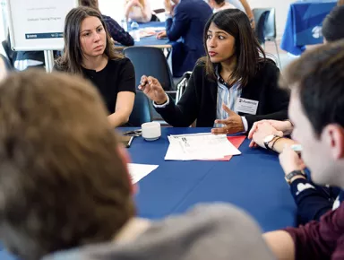 Audencia - Students debating around a table