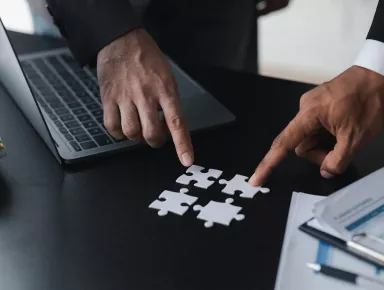 Two people handling puzzle pieces