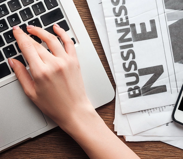 cropped image of a journalist working on a laptop computer