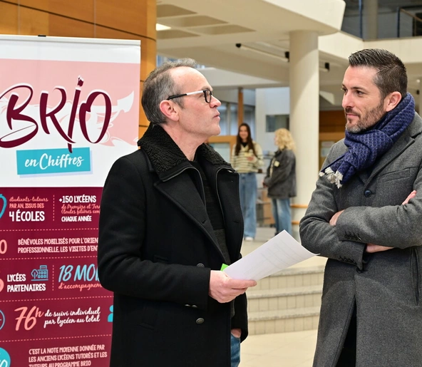 Deux personnes discutant devant un kakemono BRIO